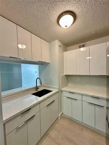 a kitchen with a sink cabinets and a sink