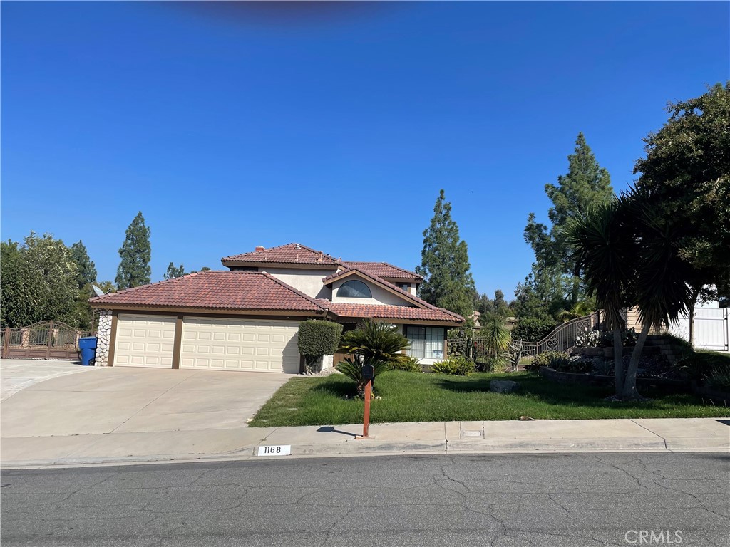 1168 Versailles Circle Riverside, CA 92506 - Photo 1 of 1 a front view of a house with a yard