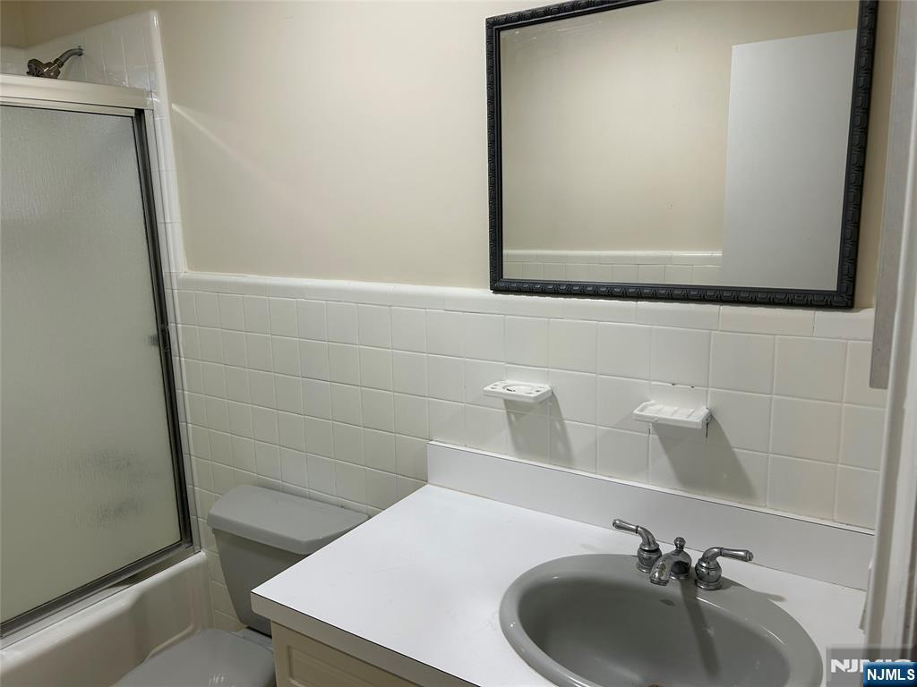 10-11 Alexander Avenue Fair Lawn, NJ 07410 - Photo 12 of 19 a bathroom with a sink and a mirror