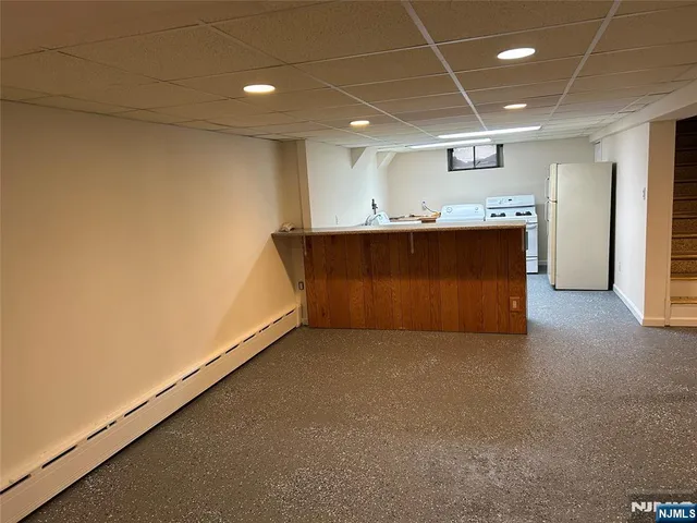 a view of kitchen and kitchen with granite countertop