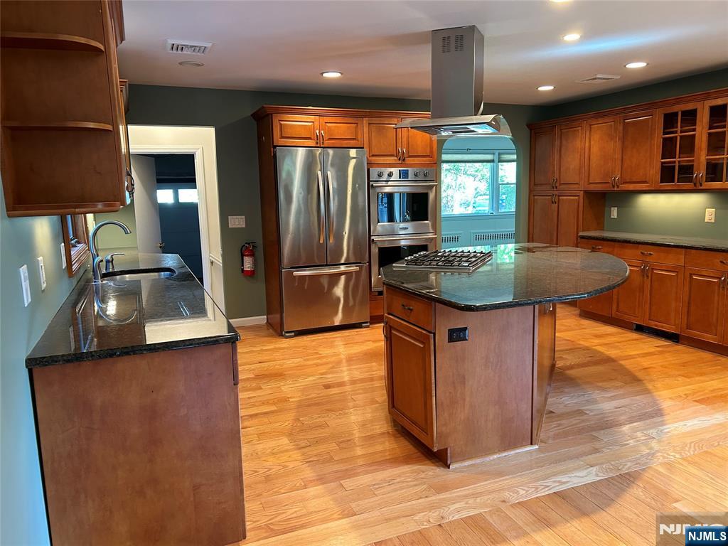 10-11 Alexander Avenue Fair Lawn, NJ 07410 - Photo 4 of 19 a kitchen with stainless steel appliances granite countertop a sink a stove and a refrigerator