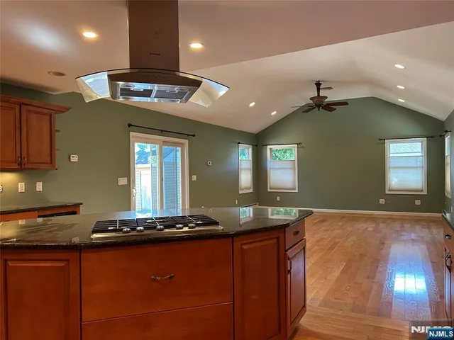 a view of kitchen with sink and refrigerator