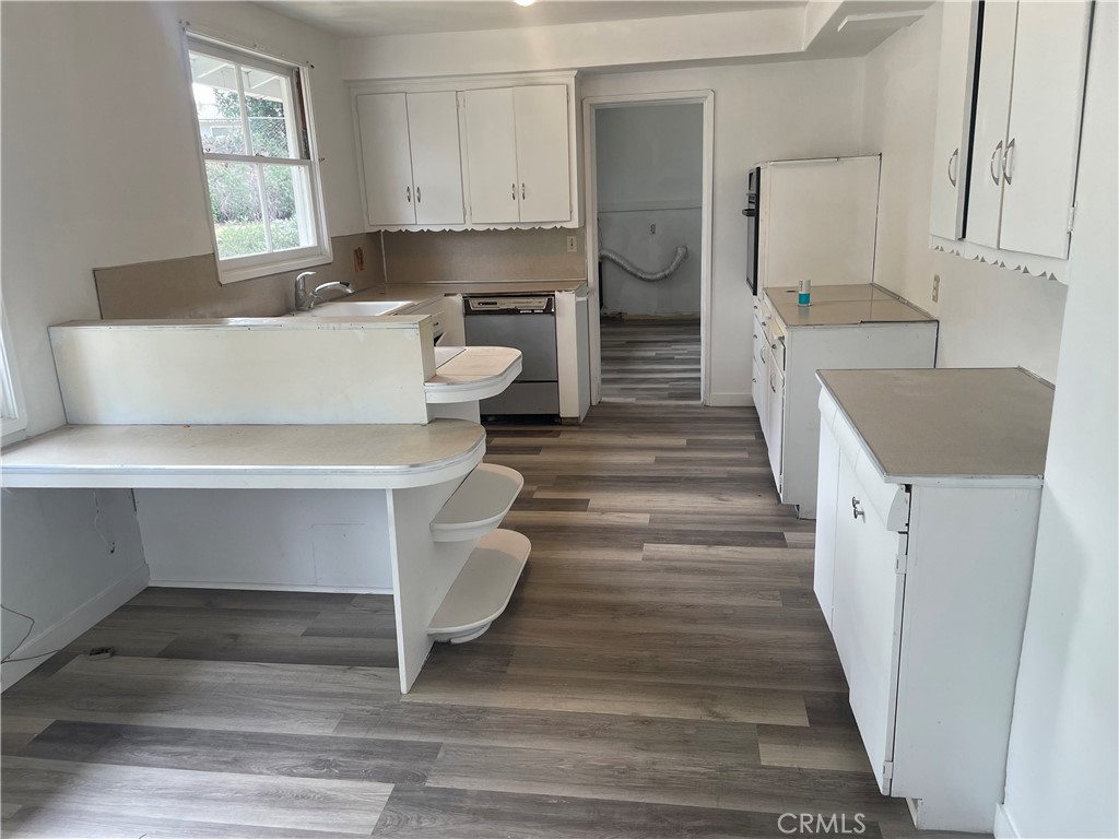 109 Miramonte Drive Fullerton, CA 92835 - Photo 8 of 13 a view of a walk in closet and bedroom with wooden floor