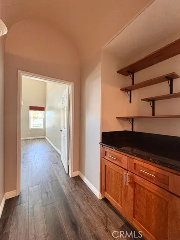 a kitchen with granite countertop a sink and wooden floor