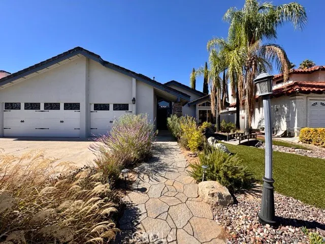 a front view of house with yard and trees around