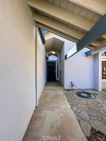a view of a hallway with wooden walls and stairs