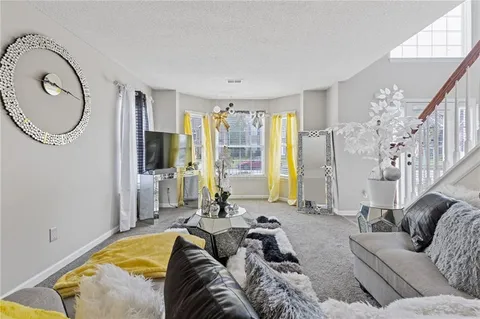 a living room with furniture bathtub and a large window