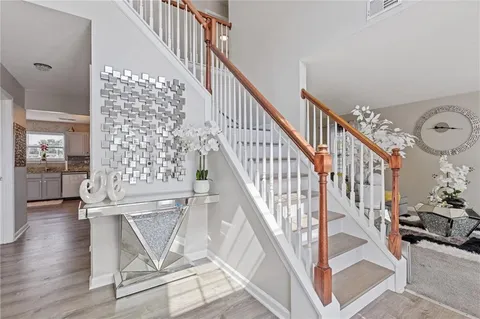 a view of entryway and hall with wooden floor