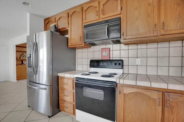 a kitchen with stainless steel appliances granite countertop a refrigerator stove a sink and dishwasher