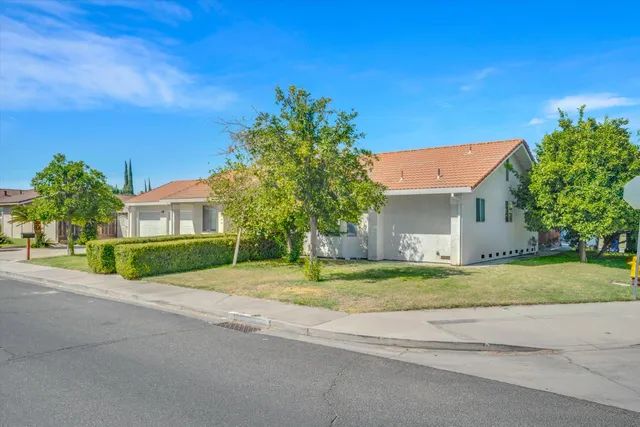 a house with huge green field in front of it