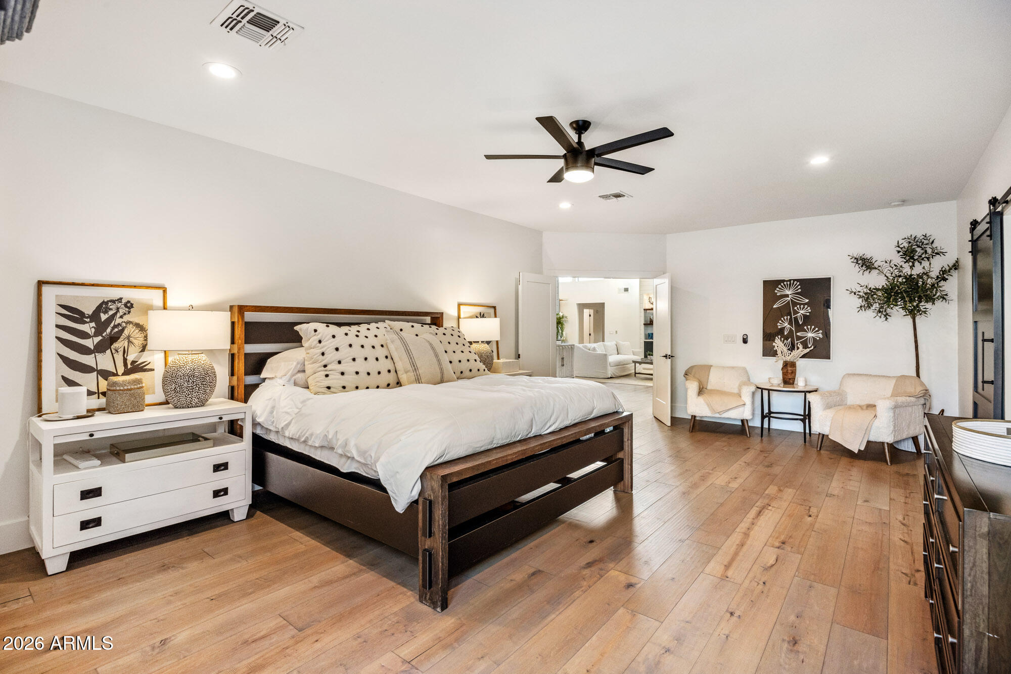 22012 North 84th Place Scottsdale, AZ 85255 - Photo 19 of 45 a spacious bedroom with a bed and a chandelier