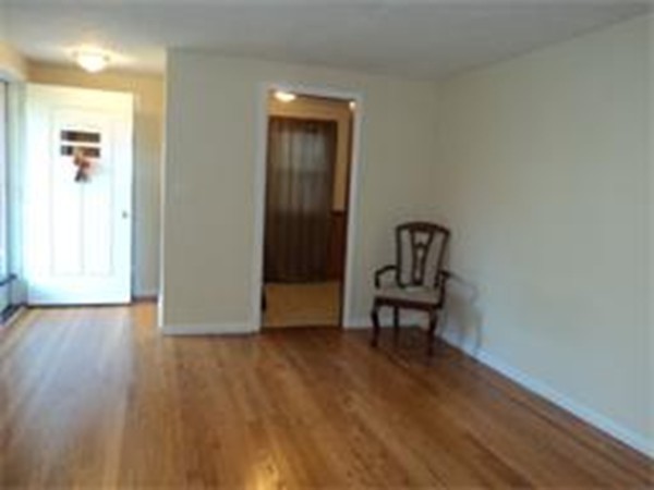 149 Cooley Street Springfield, MA 01128 - Photo 3 of 9 a view of a hallway with wooden floor and a bench