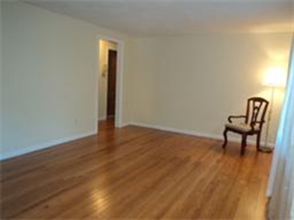 149 Cooley Street Springfield, MA 01128 - Photo 4 of 9 a view of a room with wooden floor and bench