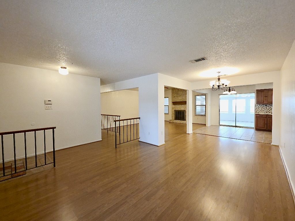 4901 Wing Road Austin, TX 78749 - Photo 3 of 28 Expansive living area with wood-finish flooring