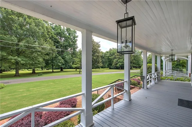 a kitchen with stainless steel appliances white cabinets and wooden floor