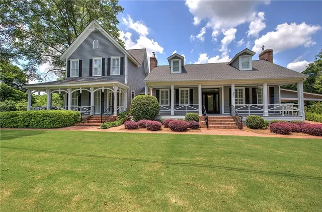 a front view of a house with yard and green space