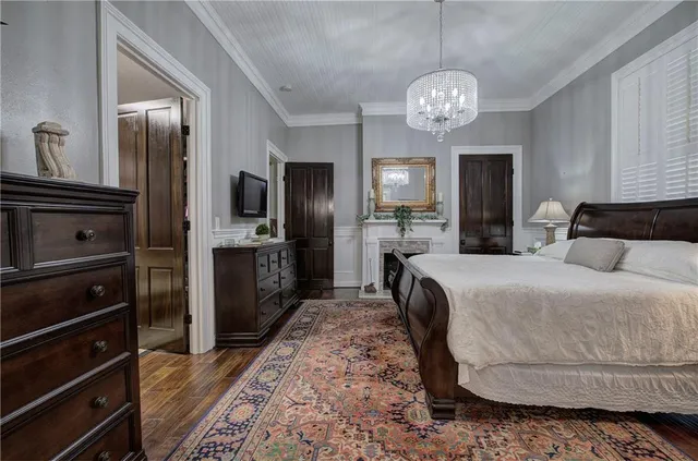 a bedroom with a large bed and a fireplace