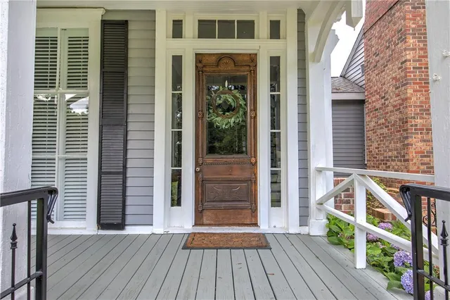 a view of a livingroom with furniture wooden floor and entryway