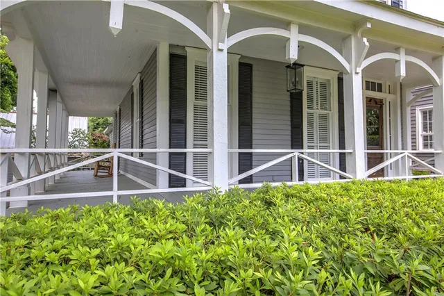 a view of a dining room with furniture a chandelier and window