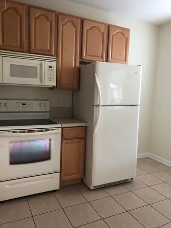 a kitchen with cabinets appliances and a sink