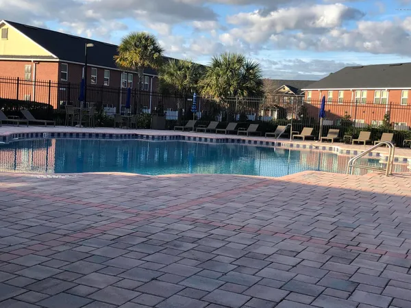 a swimming pool view with a outdoor seating