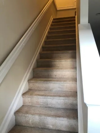 a white refrigerator freezer and a stove sitting inside of a kitchen