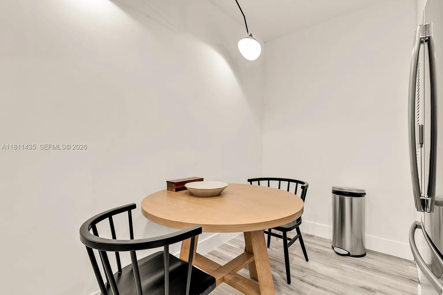 1237 Northwest 33rd Avenue Miami, FL 33125 - Photo 18 of 35 a view of a dining room with furniture and wooden floor