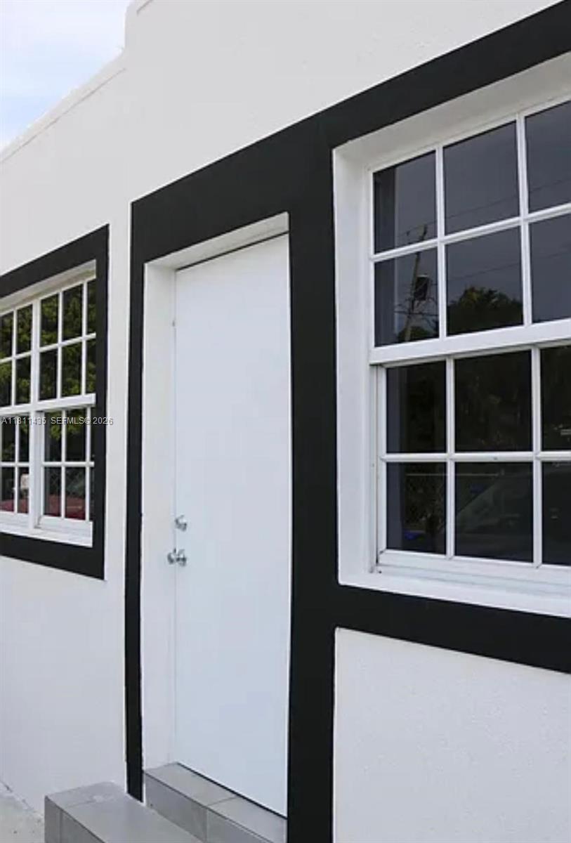 1237 Northwest 33rd Avenue Miami, FL 33125 - Photo 2 of 35 a view of front door of house