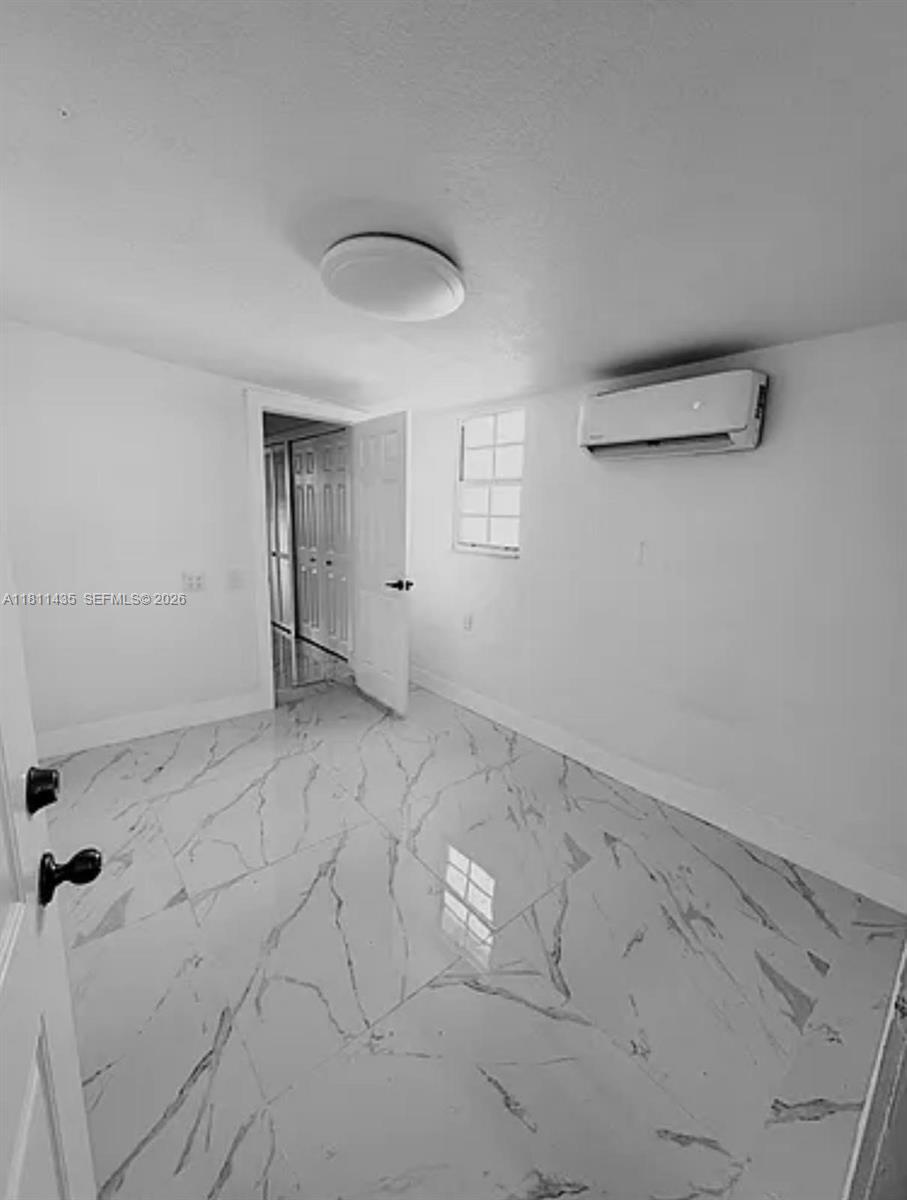 1237 Northwest 33rd Avenue Miami, FL 33125 - Photo 7 of 35 an empty room with a empty space and windows