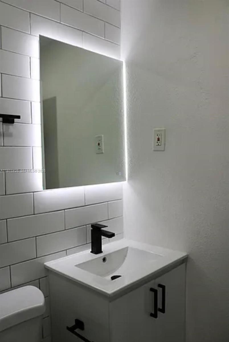 1237 Northwest 33rd Avenue Miami, FL 33125 - Photo 8 of 35 a bathroom with a sink and a mirror