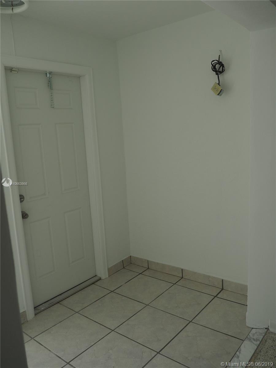 180 Northwest 59th Court Miami, FL 33126 - Photo 17 of 28 Alcove off of the Hallway with door access to the back of the home.