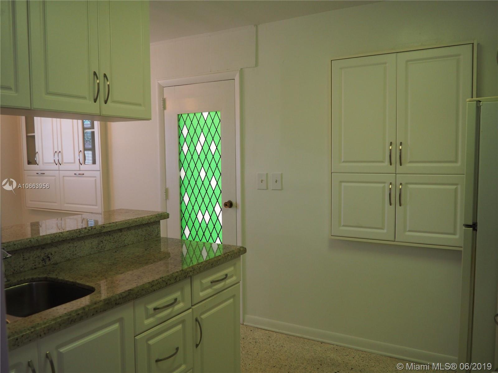 180 Northwest 59th Court Miami, FL 33126 - Photo 6 of 28 Kitchen view of door to the family room.
