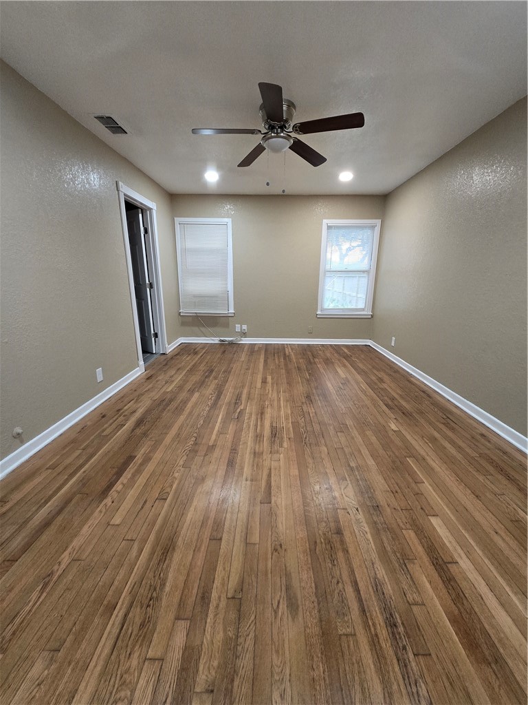 918 Stirman Street Corpus Christi, TX 78411 - Photo 11 of 13 an empty room with wooden floor and windows