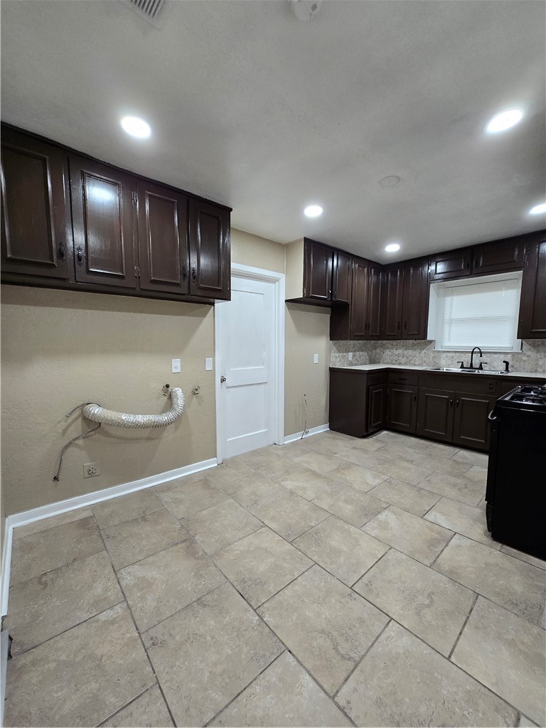918 Stirman Street Corpus Christi, TX 78411 - Photo 6 of 13 a kitchen with a sink and cabinets