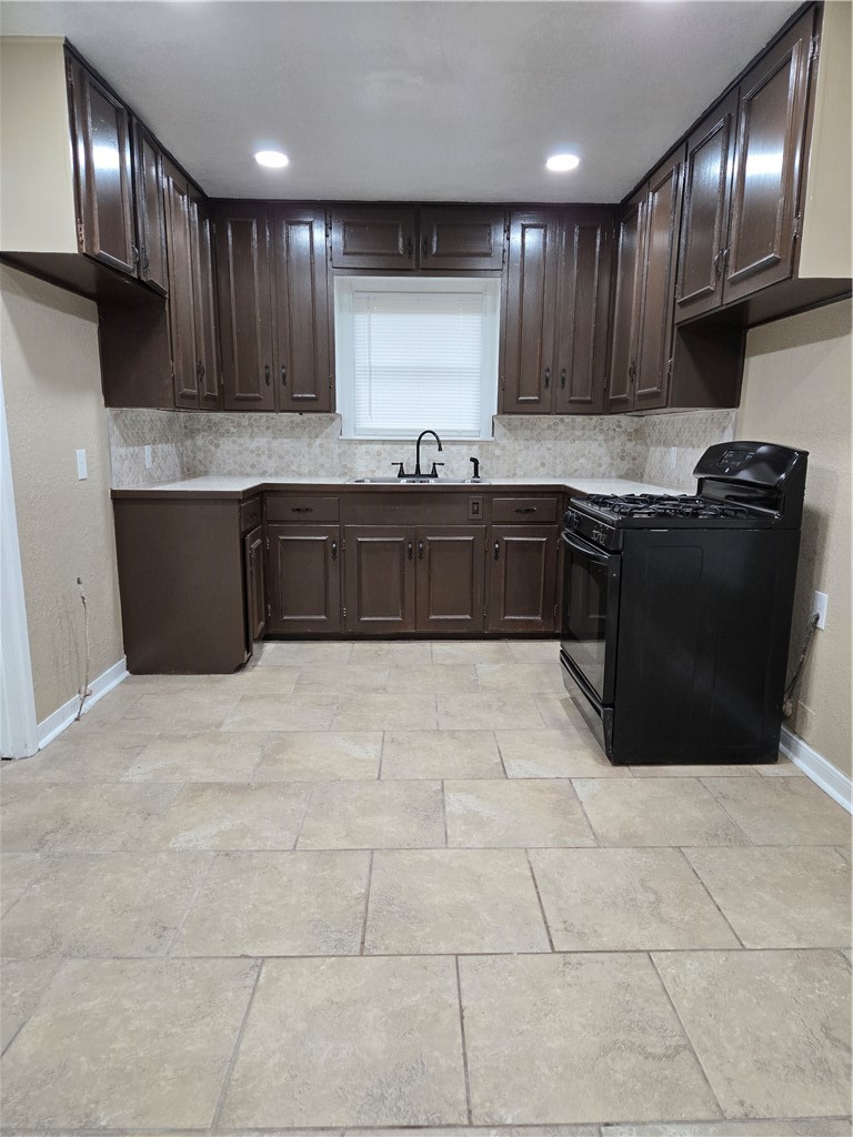 918 Stirman Street Corpus Christi, TX 78411 - Photo 7 of 13 a kitchen with granite countertop wooden cabinets and a granite counter tops