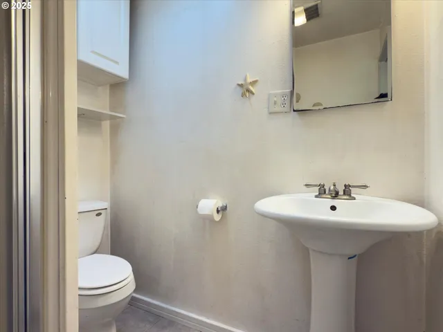 a bathroom with a sink toilet and a mirror