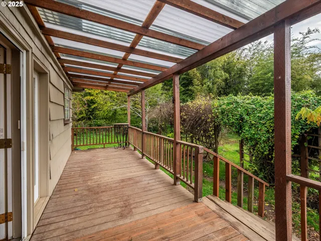 a view of a balcony with wooden floor