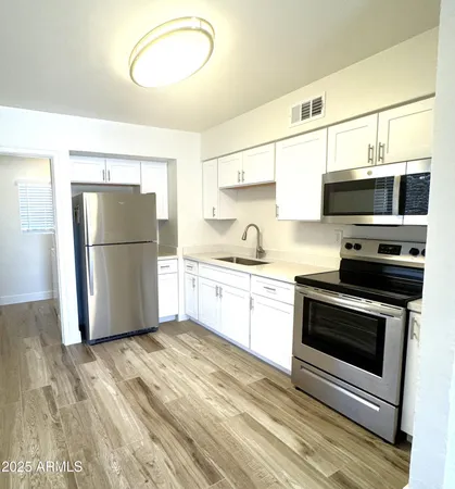 a kitchen with a refrigerator stove and microwave