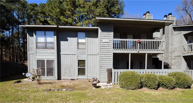 a view of a house with a yard and sitting area