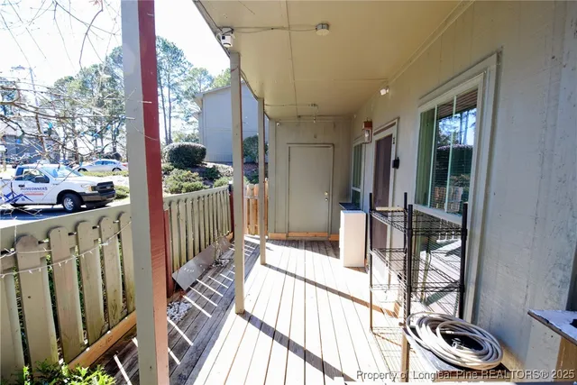 a view of a porch with wooden floor and furniture