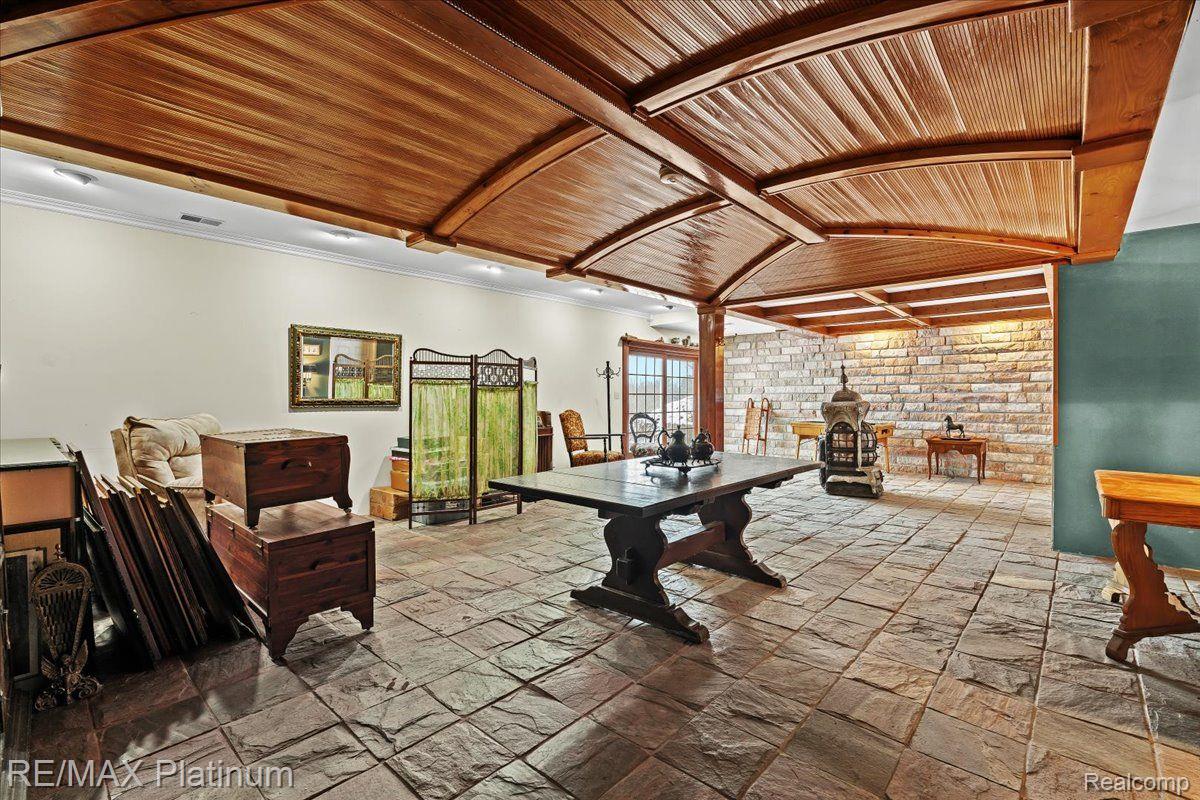 3566 Curdy Road Howell, MI 48855 - Photo 26 of 57 Walkout lower level w/slate floor & granite wall.