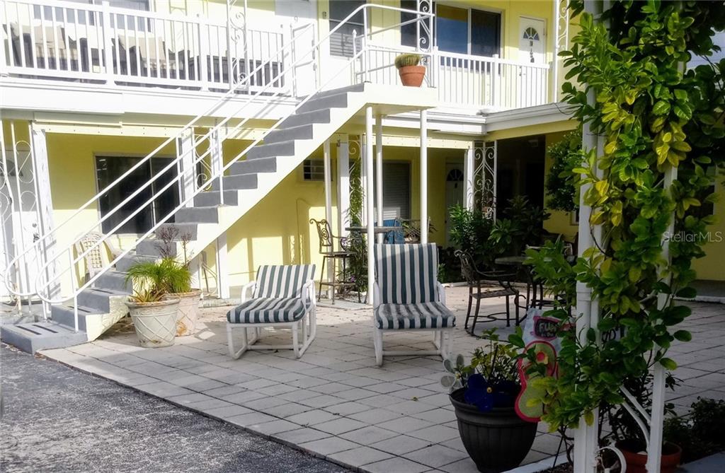 95 144th Avenue, Unit 1 Madeira Beach, FL 33708 - Photo 1 of 1 a front view of a house with a porch