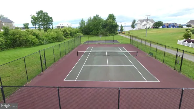 a view of a tennis court with a small yard