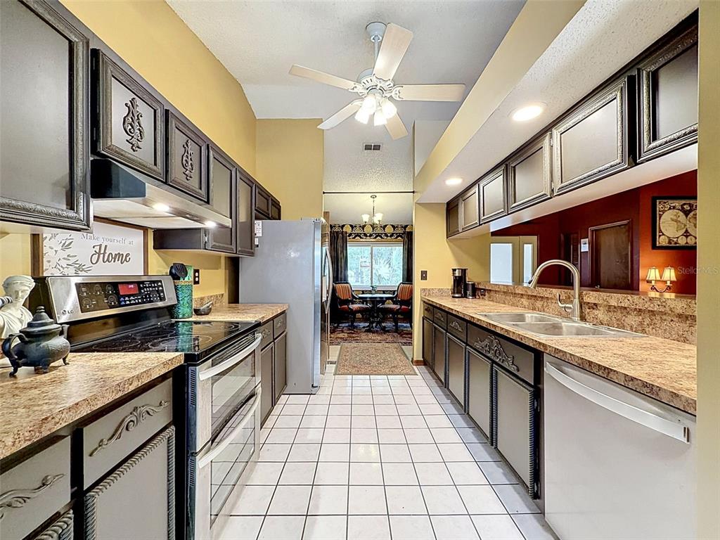 7111 Ricker Avenue Webster, FL 33597 - Photo 13 of 41 a large kitchen with stainless steel appliances granite countertop a sink and cabinets