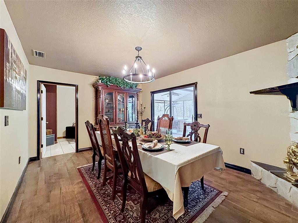 7111 Ricker Avenue Webster, FL 33597 - Photo 16 of 41 a view of a dining room with furniture and chandelier