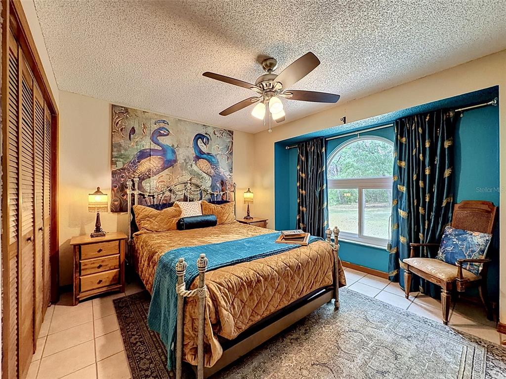 7111 Ricker Avenue Webster, FL 33597 - Photo 23 of 41 a bedroom with a bed and a couch