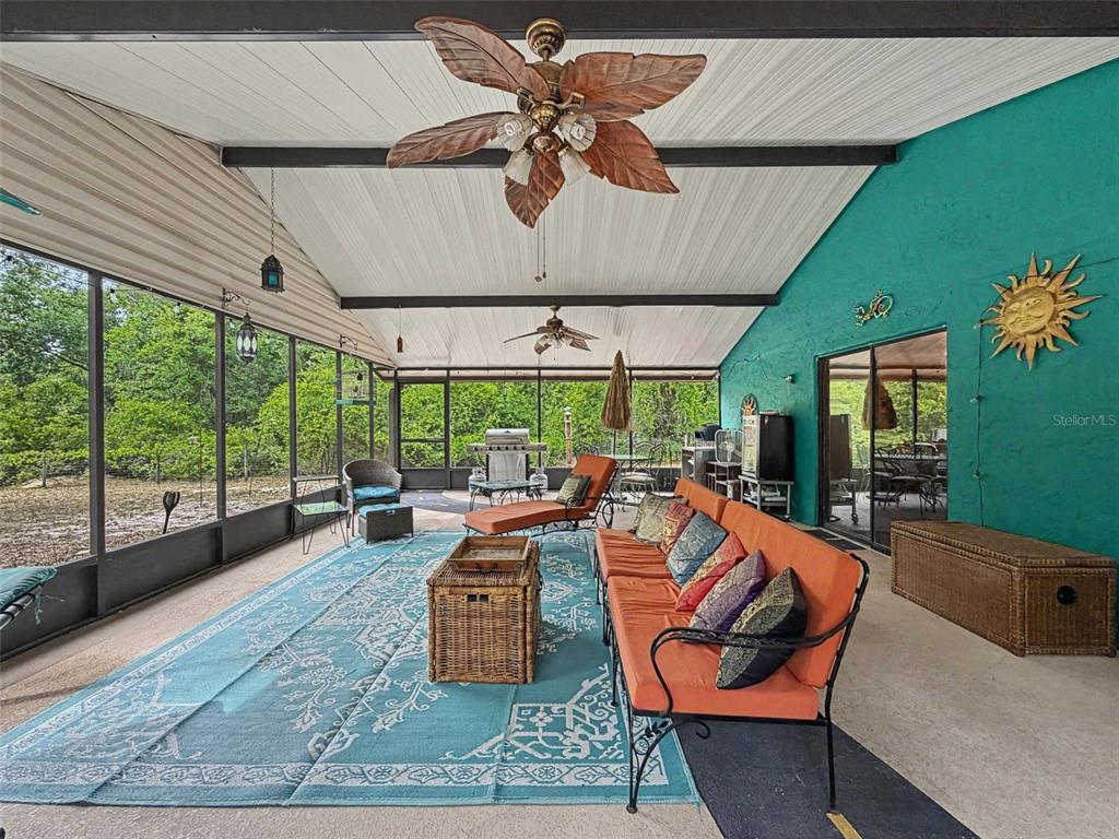 7111 Ricker Avenue Webster, FL 33597 - Photo 32 of 41 a living room with patio furniture and a floor to ceiling window