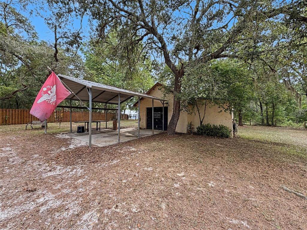 7111 Ricker Avenue Webster, FL 33597 - Photo 36 of 41 a view of a house with backyard and a tree