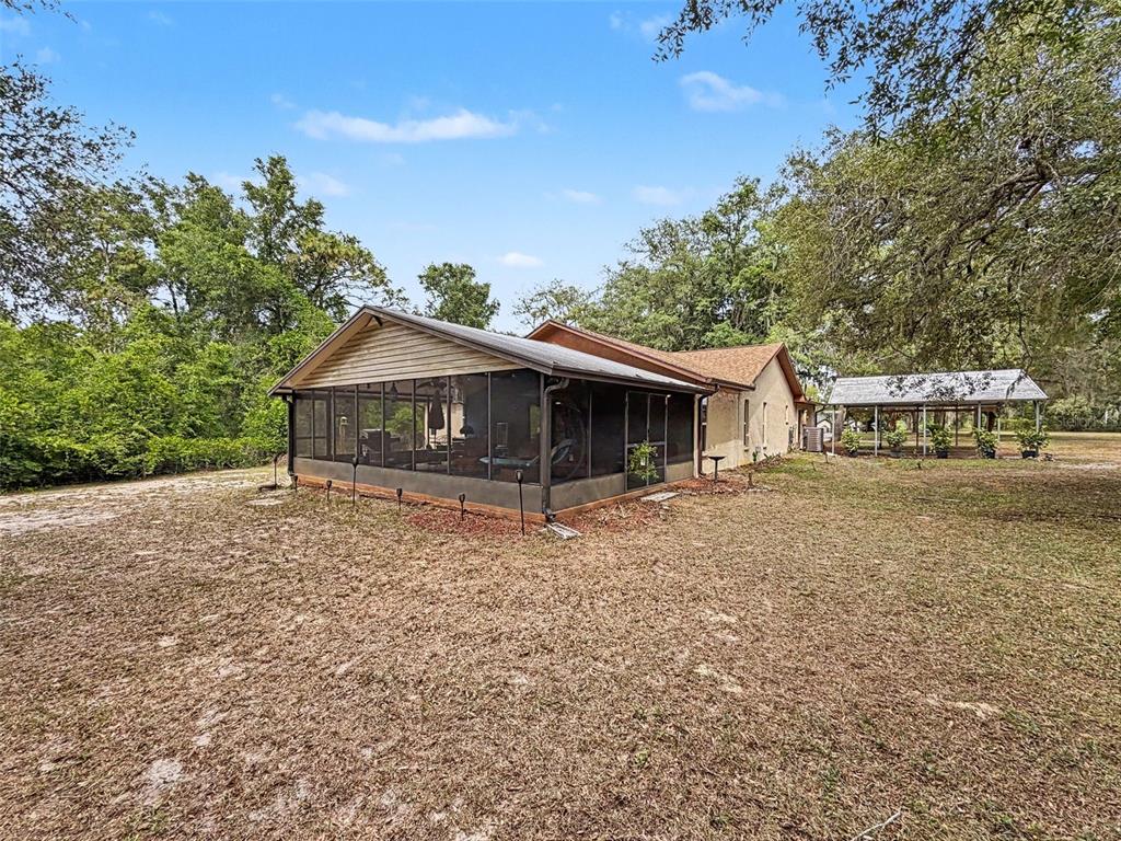 7111 Ricker Avenue Webster, FL 33597 - Photo 38 of 41 a house with trees in the background