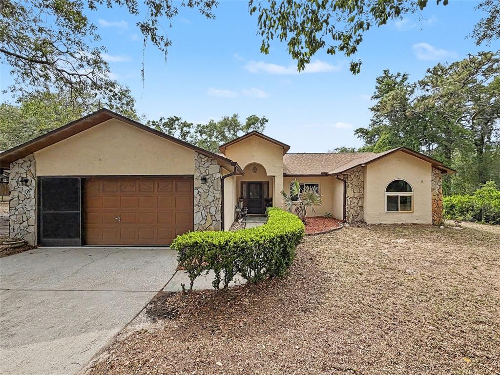 7111 Ricker Avenue Webster, FL 33597 - Photo 7 of 41 a front view of a house with a yard and garage